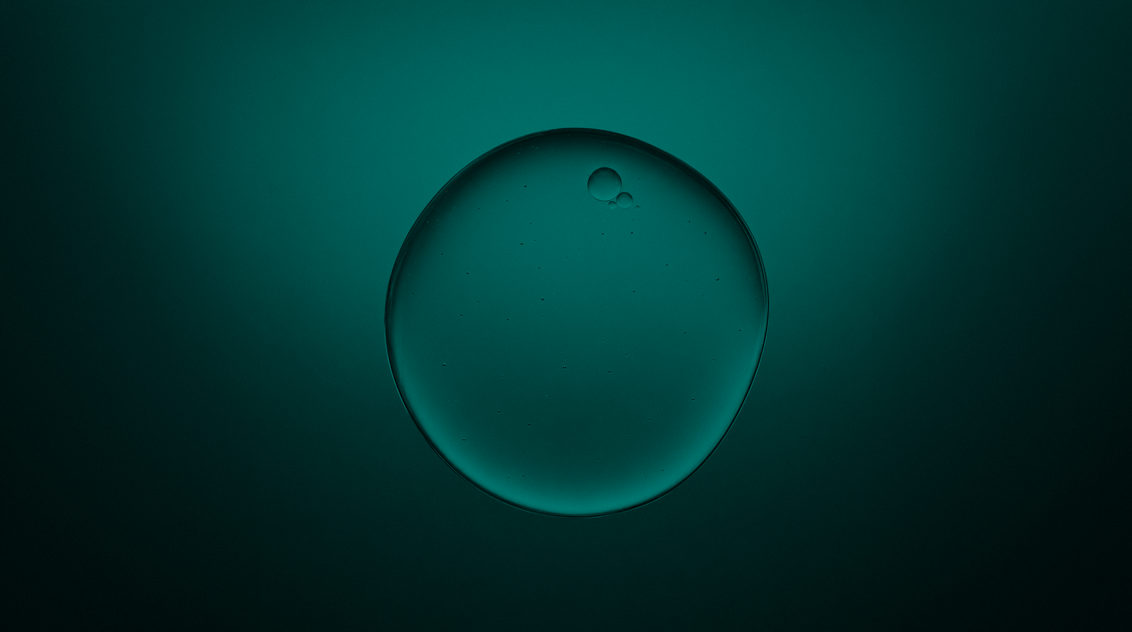A single translucent serum droplet symbolizing concentrated skincare ingredients