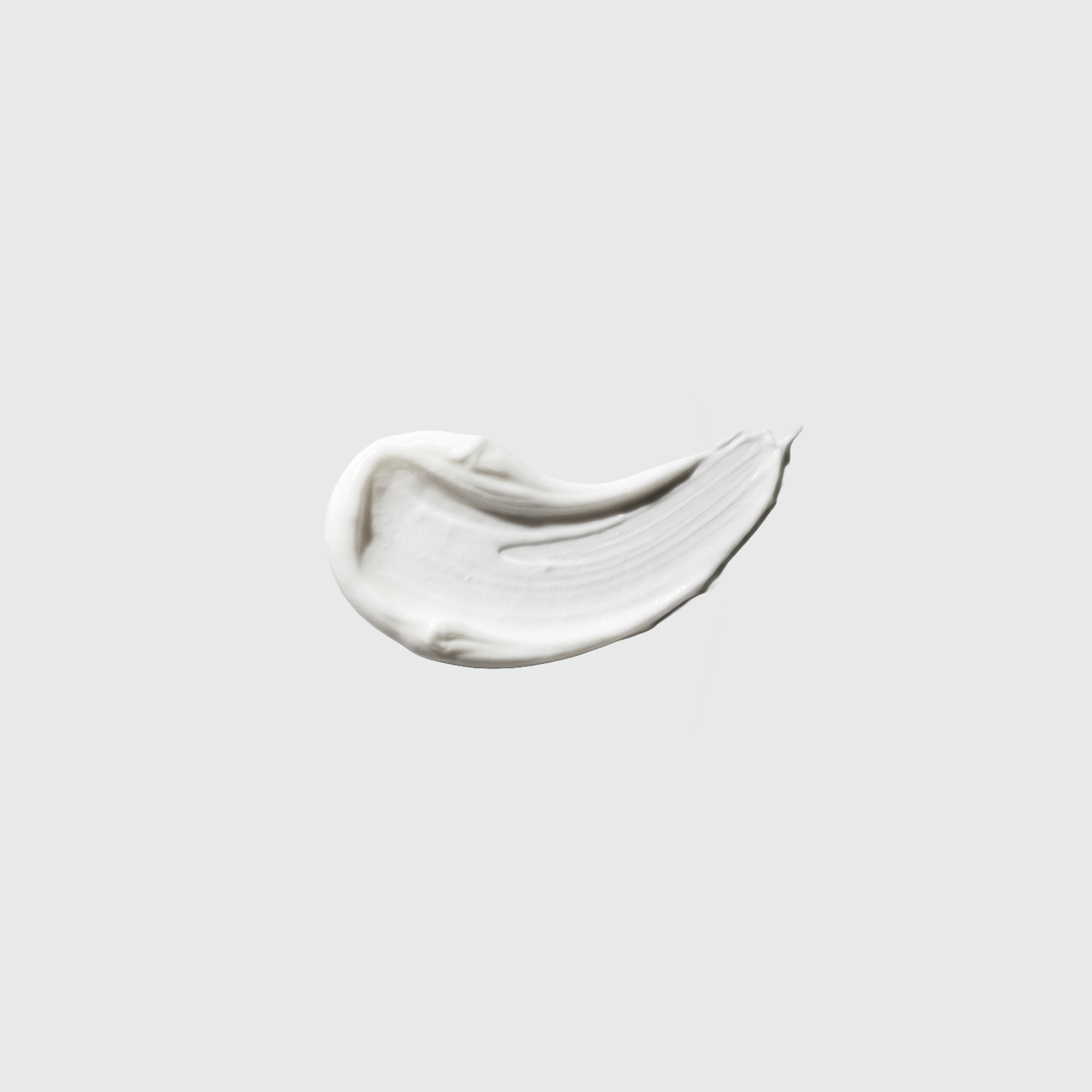 White cream texture with a smooth swipe on a light gray background